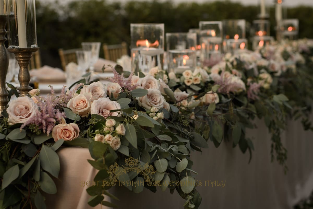 floral garland for the top table during wedding reception in the castle in italy - Luxury Indian wedding on the lake in Italy