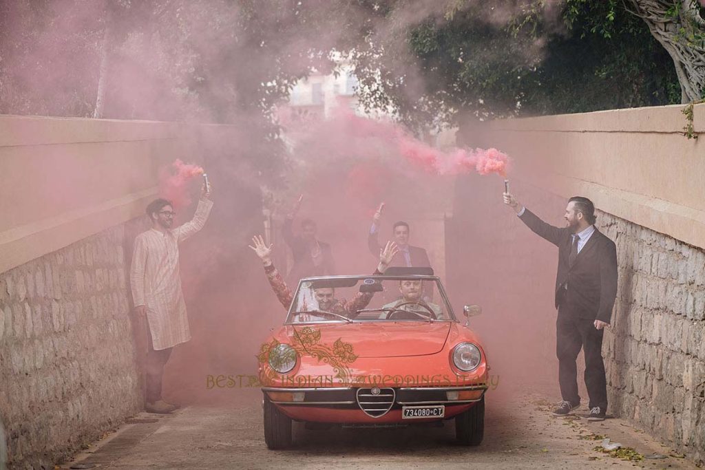 baraat with red flares italy 1024x683 - A Cross-Cultural Fairytale in Sicily: A South-Indian Wedding Celebration Overlooking the Sea