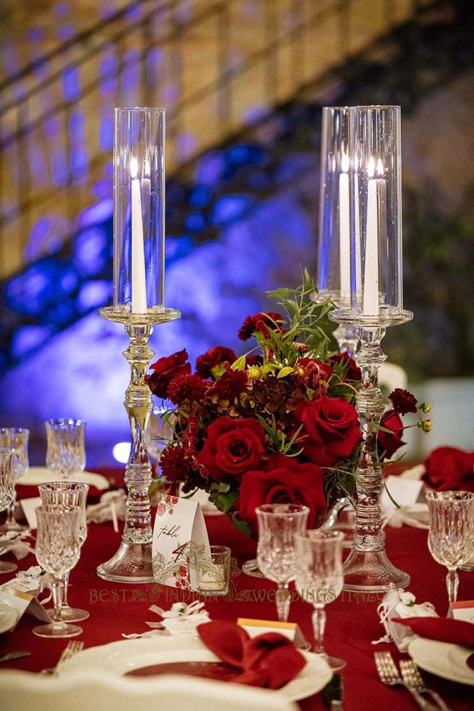 red wedding flowers reception decor 683x1024 - A Cross-Cultural Fairytale in Sicily: A South-Indian Wedding Celebration Overlooking the Sea